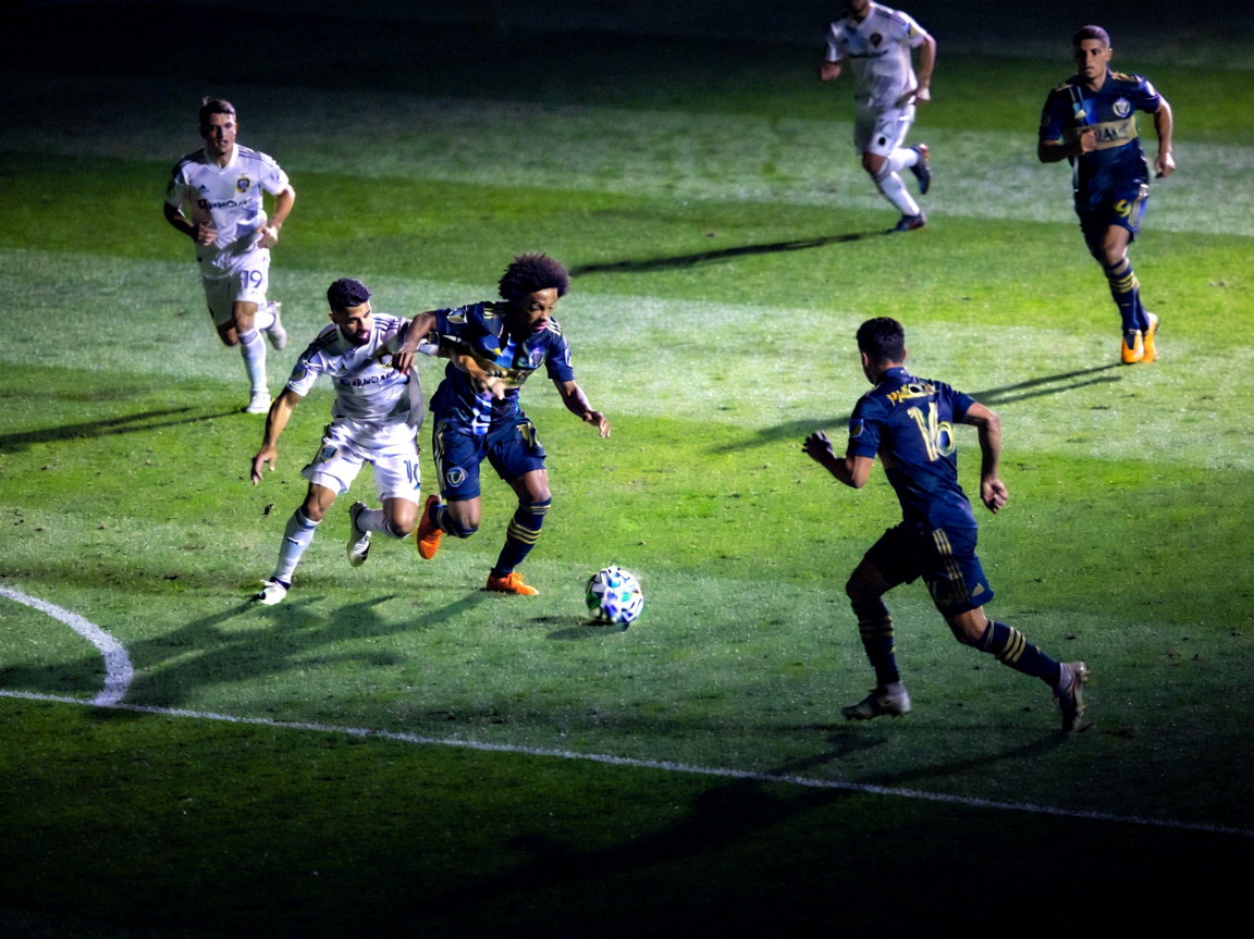 高清足球赛事直播画面，显示球员在绿茵场上激烈拼抢的瞬间